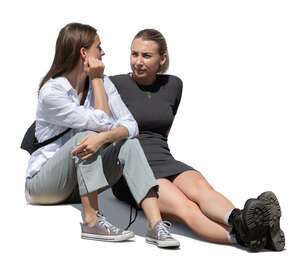 two cut out young women sitting on the sidewalk and talking