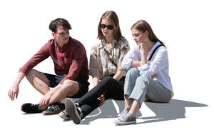 three cut out young people sitting on the sidewalk and talking