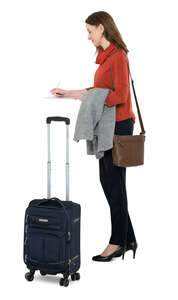 cut out woman with a suitcase checking into a hotel