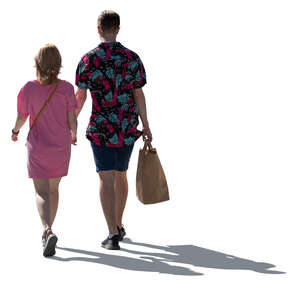 cut out backlit man and woman walking hand in hand