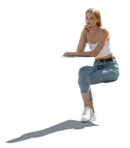 cut out backlit woman sitting and leaning on a table