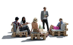 cut out group of young people hanging in a cafe with pallet furniture