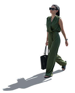 cut out backlit woman in a green jumpsuit walking