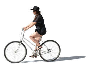 cut out woman in a black dress and hat riding a bike