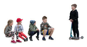 cut out group of children sitting and talking to a boy with a scooter