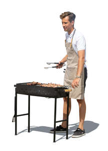 cut out man grilling meat on an outdoor barbeque stove