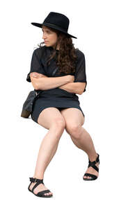 cut out woman in a black dress wearing black hat sitting