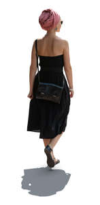 cut out woman in a black summer dress wearing headscarf walking