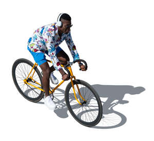 cut out black man with headphones riding a bike seen from above
