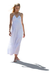 cut out backlit woman in a white dress walking barefoot