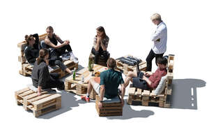 cut out group of friends sitting on pallet garden furniture