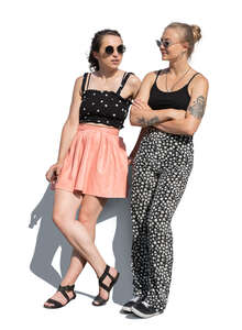 two cut out young women standing and leaning on a table edge