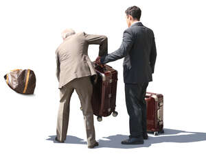 hotel porter and taxi driver loading bags in the trunk