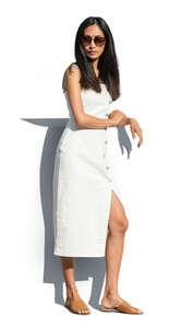 cut out asian woman in a white dress standing and leaning on a railing