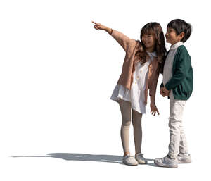 two cut out happy asian kids standing and pointing at smth