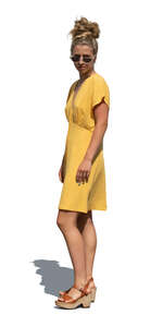 cut out woman in a yellow summer dress standing