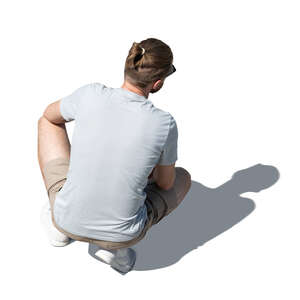 cut out man squatting seen from above