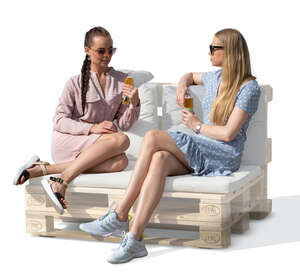 two cut out women sitting on a sofa and drinking lemonade