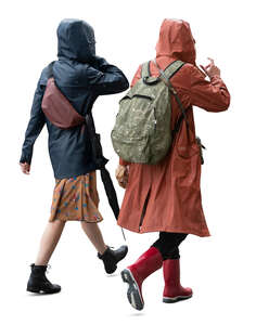 two cut out women wearing raincoats walking