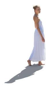 cut out woman in a white dress walking barefoot