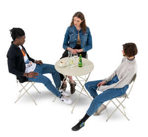 cut out top view of a group of three friends sitting in a cafe 