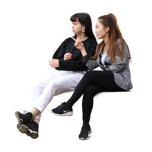 two cut out women sitting and talking