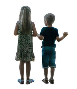 two cut out children standing at the window