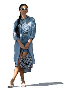 cut out woman in a blue summer costume standing under a tree shade