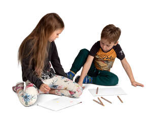 two cut out kids sitting on the floor and drawing