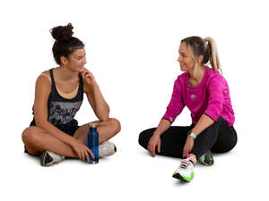 two cut out women sitting and talking after workout