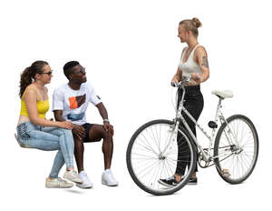 two cut out people sitting and talking to a woman with a bike