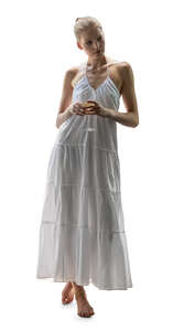 cut out woman in a white long dress standing and drinking wine