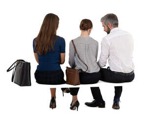 three cut out people sitting seen from back angle
