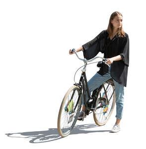 cut out sidelit young woman with a bike standing