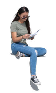 cut out woman sitting outside and reading a book