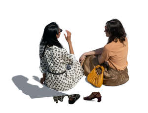 two cut out women sitting and talking seen from above