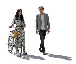 cut out backlit man and a woman with a bike walking and talking