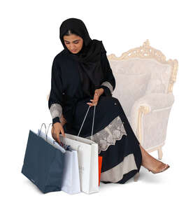 cut out muslim woman with shopping bags sitting