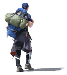 man with a hiking backpack walking in the sunlight