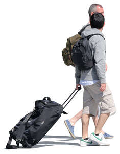 two men with backpacks and suitcases walking down the street