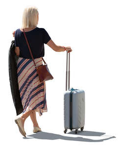 backlit woman woth a suitcase standing