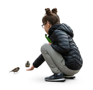 cut out girl squatting and feeding pigeons