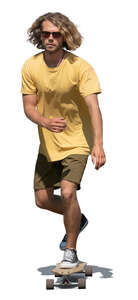 young man with curly hair riding a skateboard