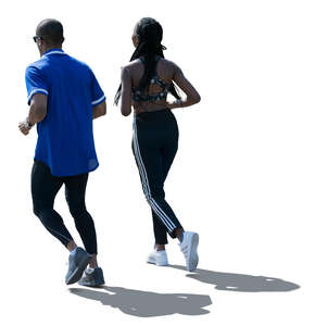 backlit man and woman jogging