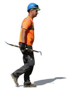 worker with a helmet walking with a crowbar in his hand