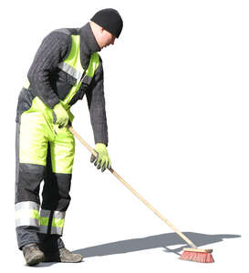 man with street brush doing spring cleaning