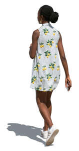 black woman in a light summer dress walking