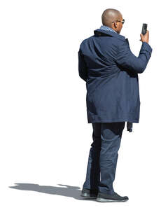 black man standing and taking a picture with his phone