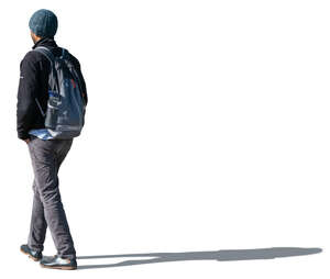 indian man in autumn jacket and hat walking