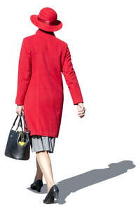 middle aged woman in a red hat and overcoat walking